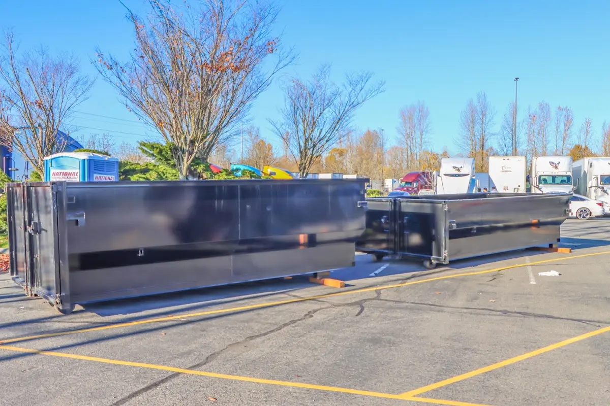 Professional dumpster rental service with roll-off container on residential driveway in Midland